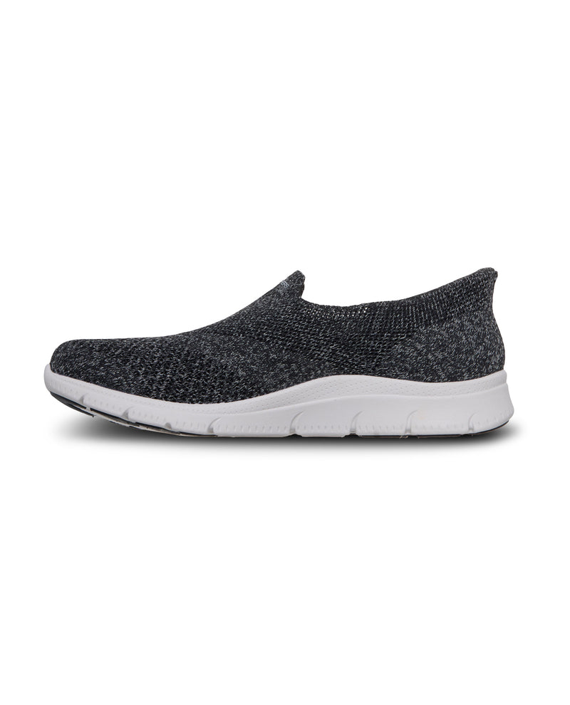 Black slip-on shoe with white sole on a white background