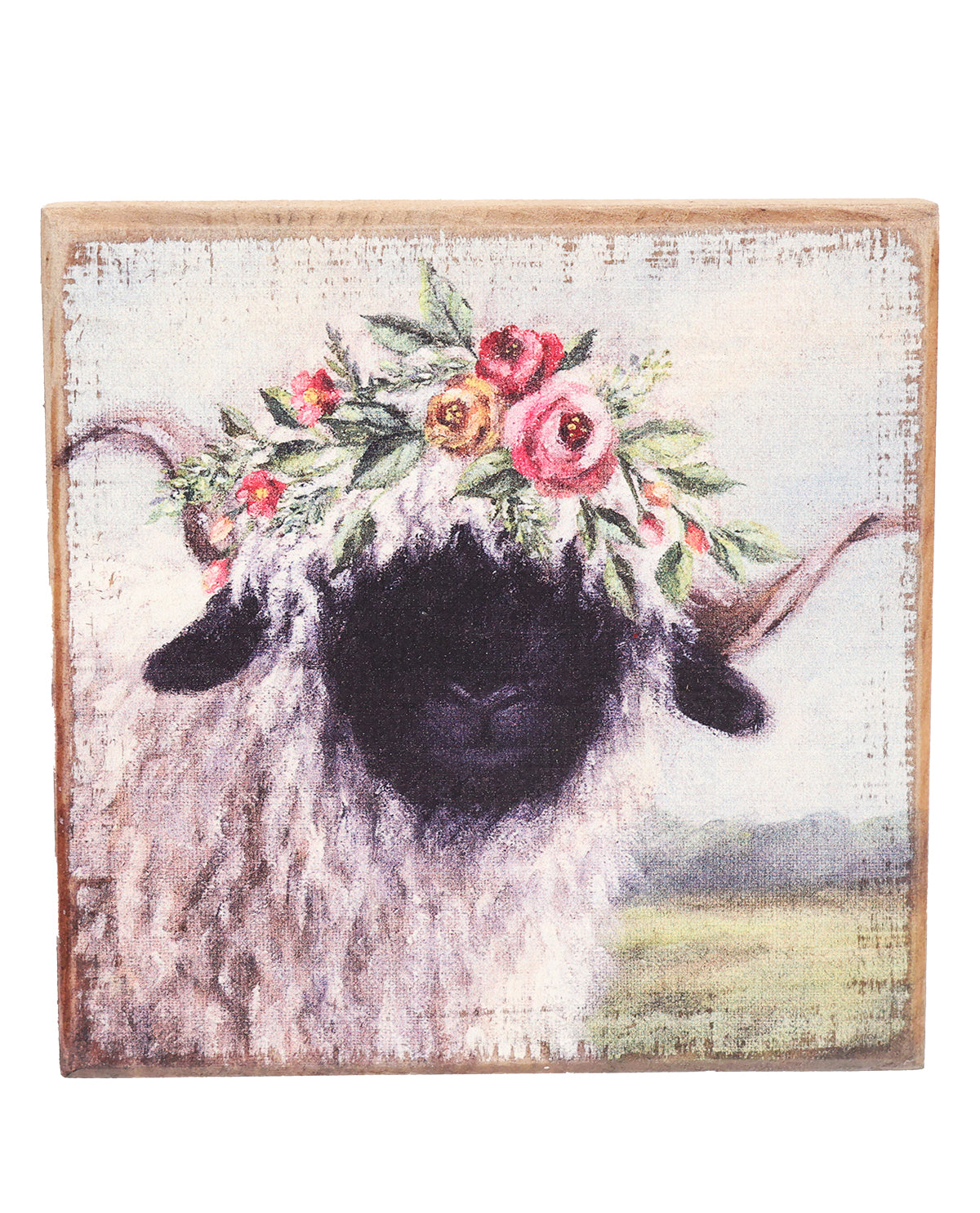 Decorative wall art of a sheep with floral crown on a wooden frame.