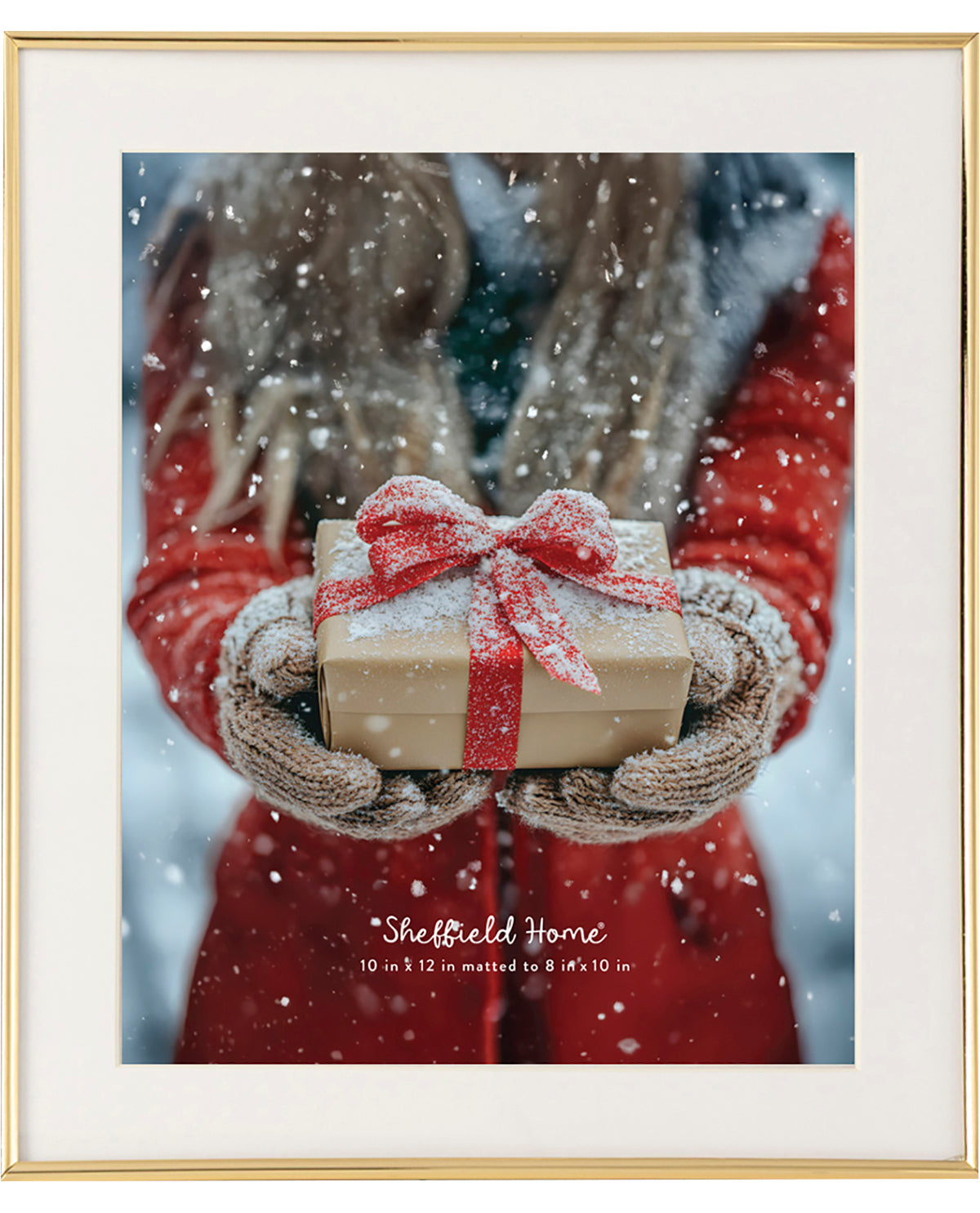 Framed print of hands holding a gift with a red ribbon against a snowy background, featuring 'Sheffield Home' branding.