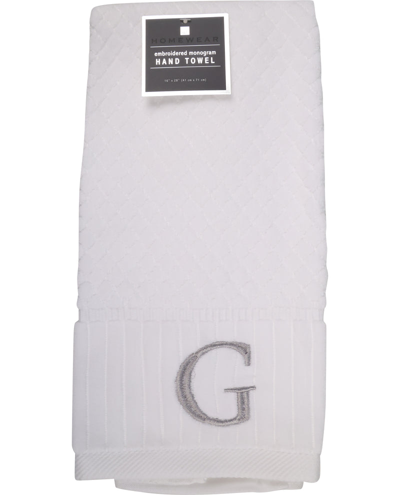 White hand towel with gray embroidered letter 'G' on a white background