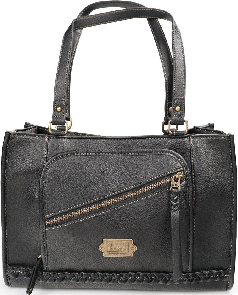 A black pebbled leather handbag with dual top handles, a diagonal zippered front pocket, braided trim along the bottom, and a small gold-tone brand plaque on the front.