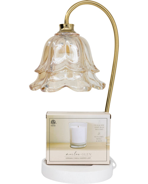 Decorative table lamp with a glass shade and white base on a white background