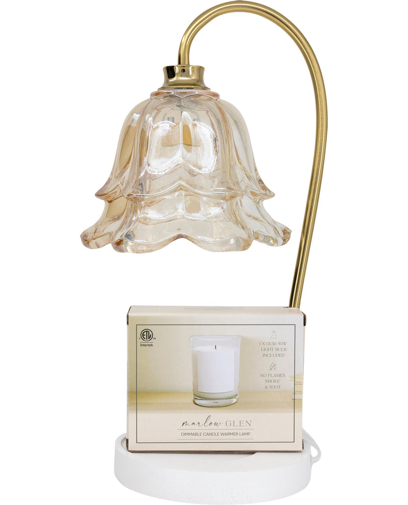 Decorative table lamp with a glass shade and white base on a white background