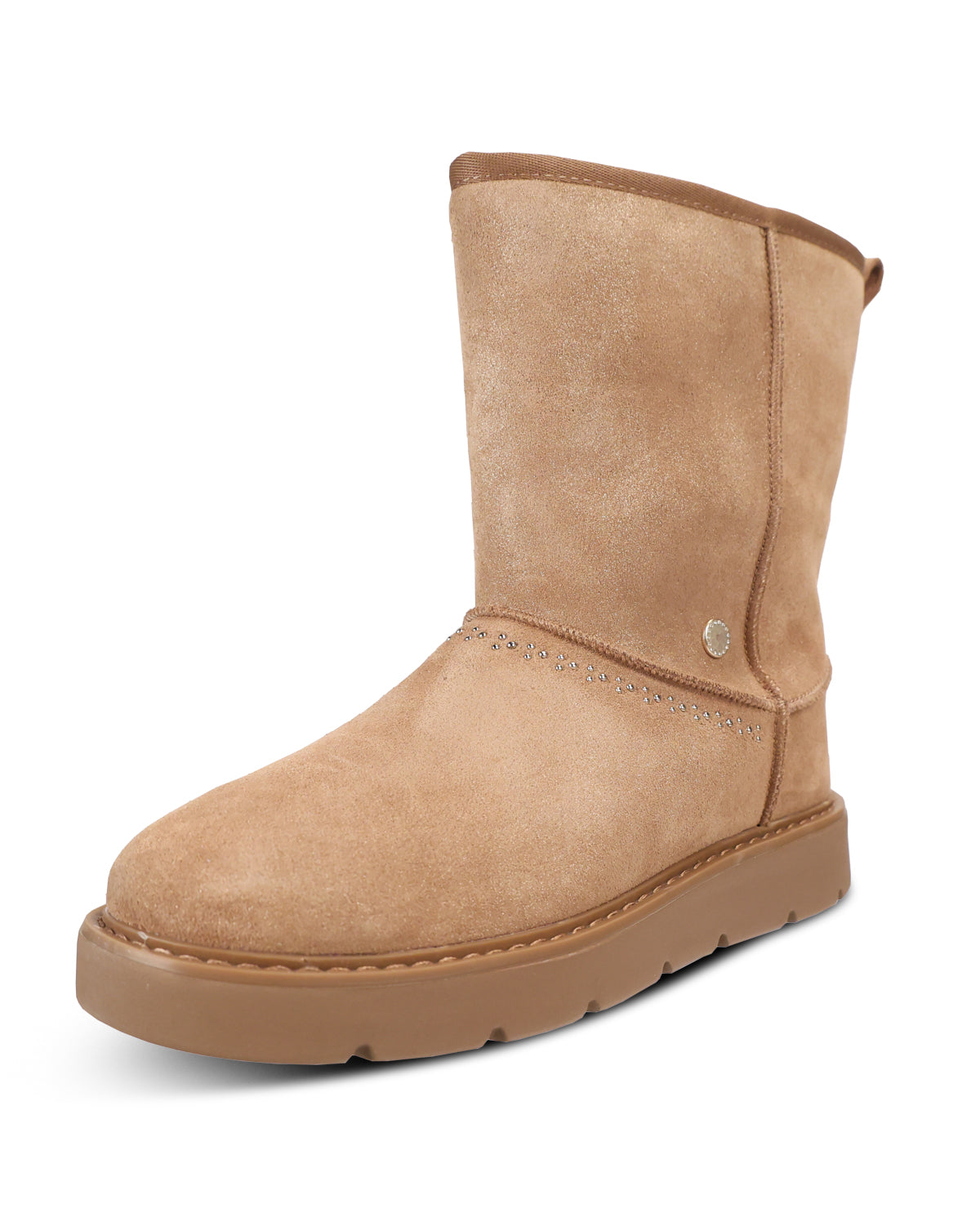 A mid-calf suede boot in a warm tan/beige color, featuring a thick matching sole and a small metallic logo badge on the side, shown against a plain white background.