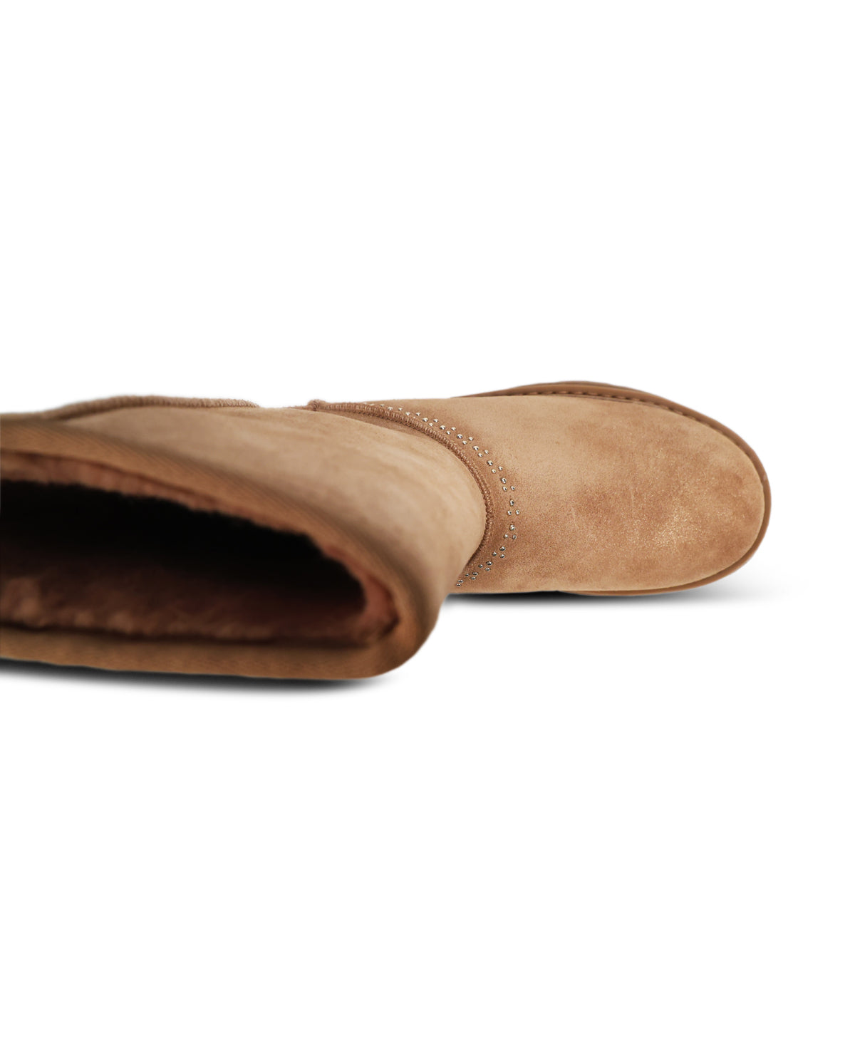 A close-up side view of a tan suede boot with a dark brown shearling lining, shown on a clean white background.