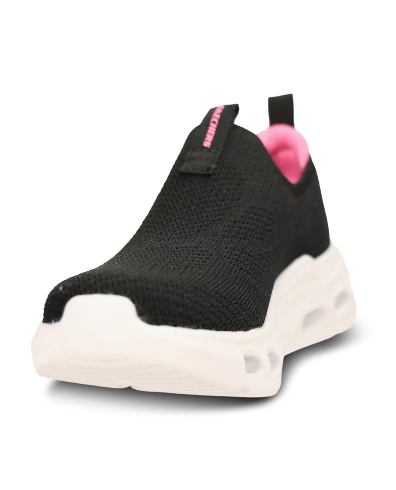 A black slip-on knit sneaker with a chunky white sole and a bright pink inner lining and pull tab accent.