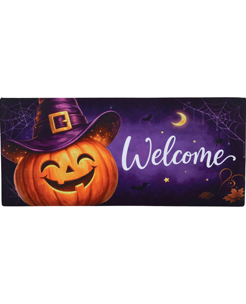 A rectangular Halloween-themed decorative sign or mat with a carved orange pumpkin wearing a purple witch hat on the left, a purple night sky background with spiderwebs, bats, a crescent moon, stars, and the word 'Welcome' in white script on the right.