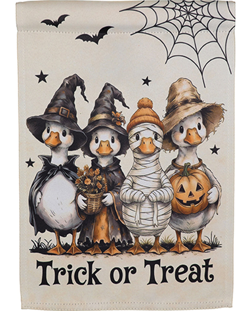 Halloween-themed towel with cartoon ducks in costumes and 'Trick or Treat' text.