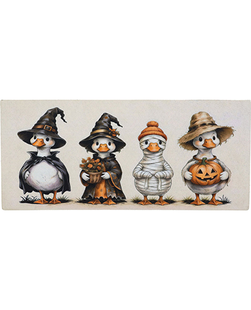 Four cartoon ducks dressed in Halloween costumes on a beige background