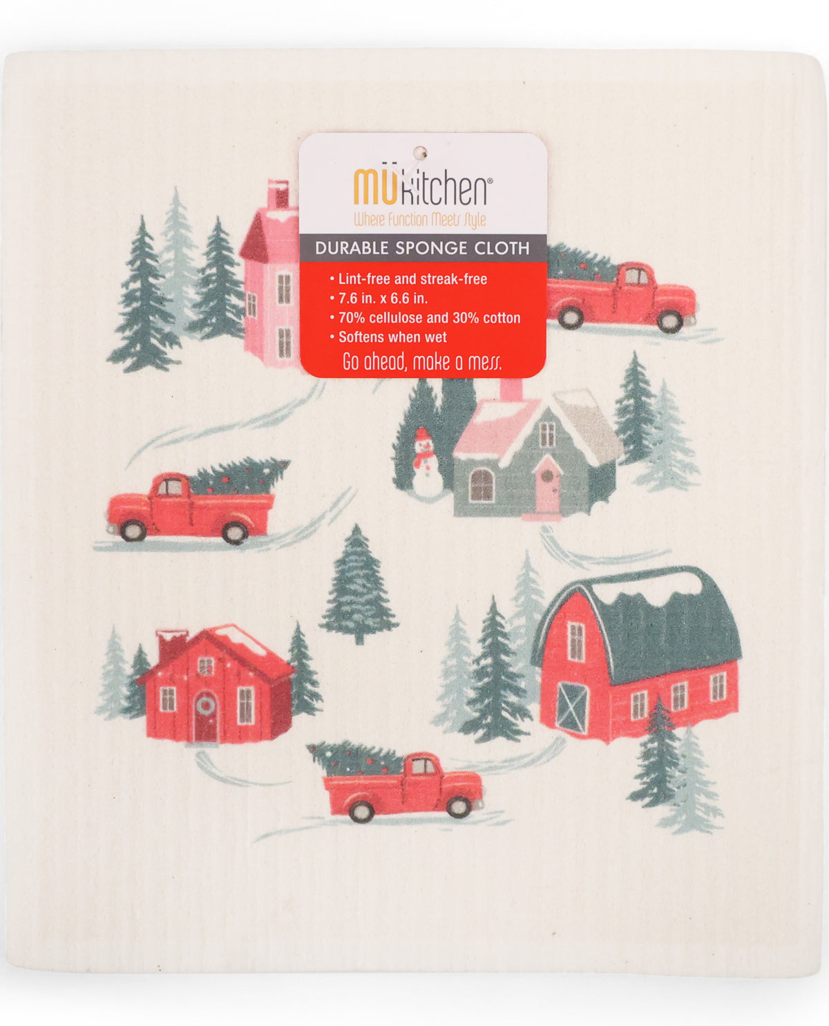 A rectangular kitchen sponge cloth with a festive Christmas village print, featuring red pickup trucks, pine trees, and cabins on an off-white background. A red and white 'mukitchen' brand label is attached at the top.