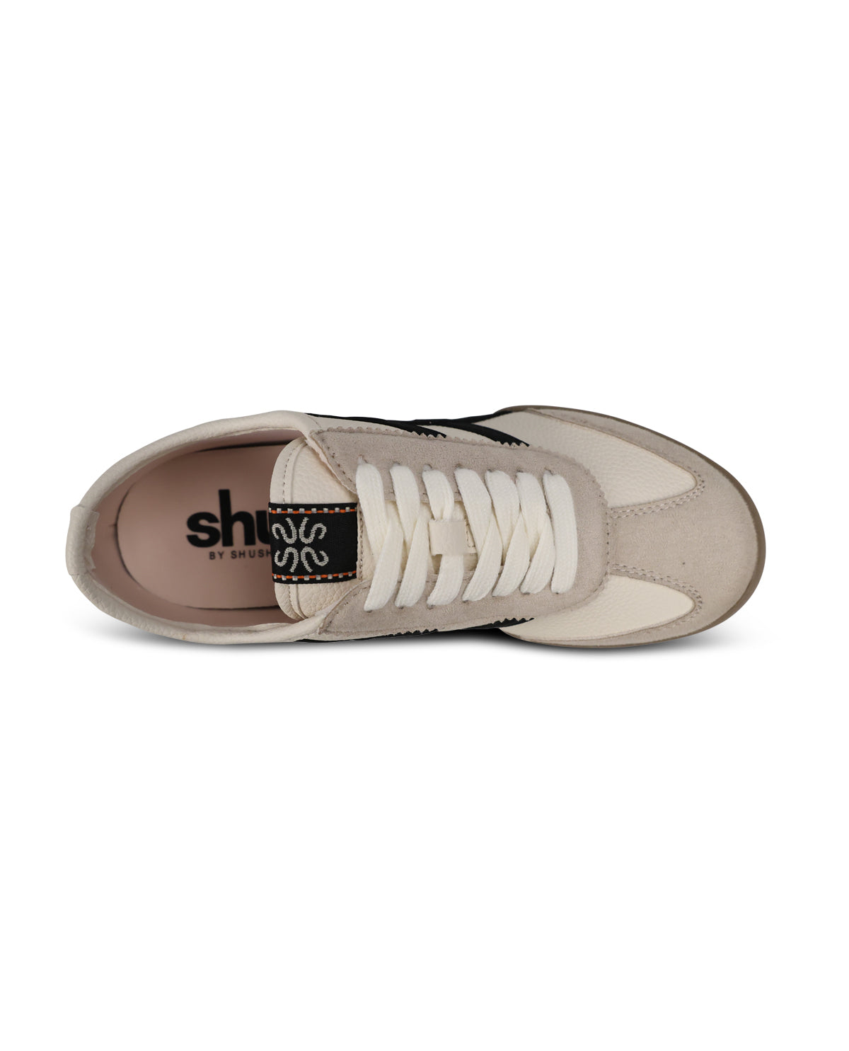 A single low-top sneaker shown from a top-down view on a plain white background. The shoe features a light beige suede and mesh upper with cream laces, a black heel tab with white branding, and a beige outsole.