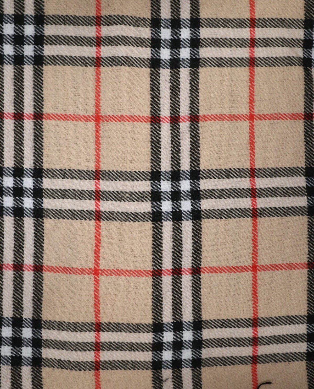A close-up of a classic plaid pattern featuring a beige base with black, white, and red intersecting stripes.