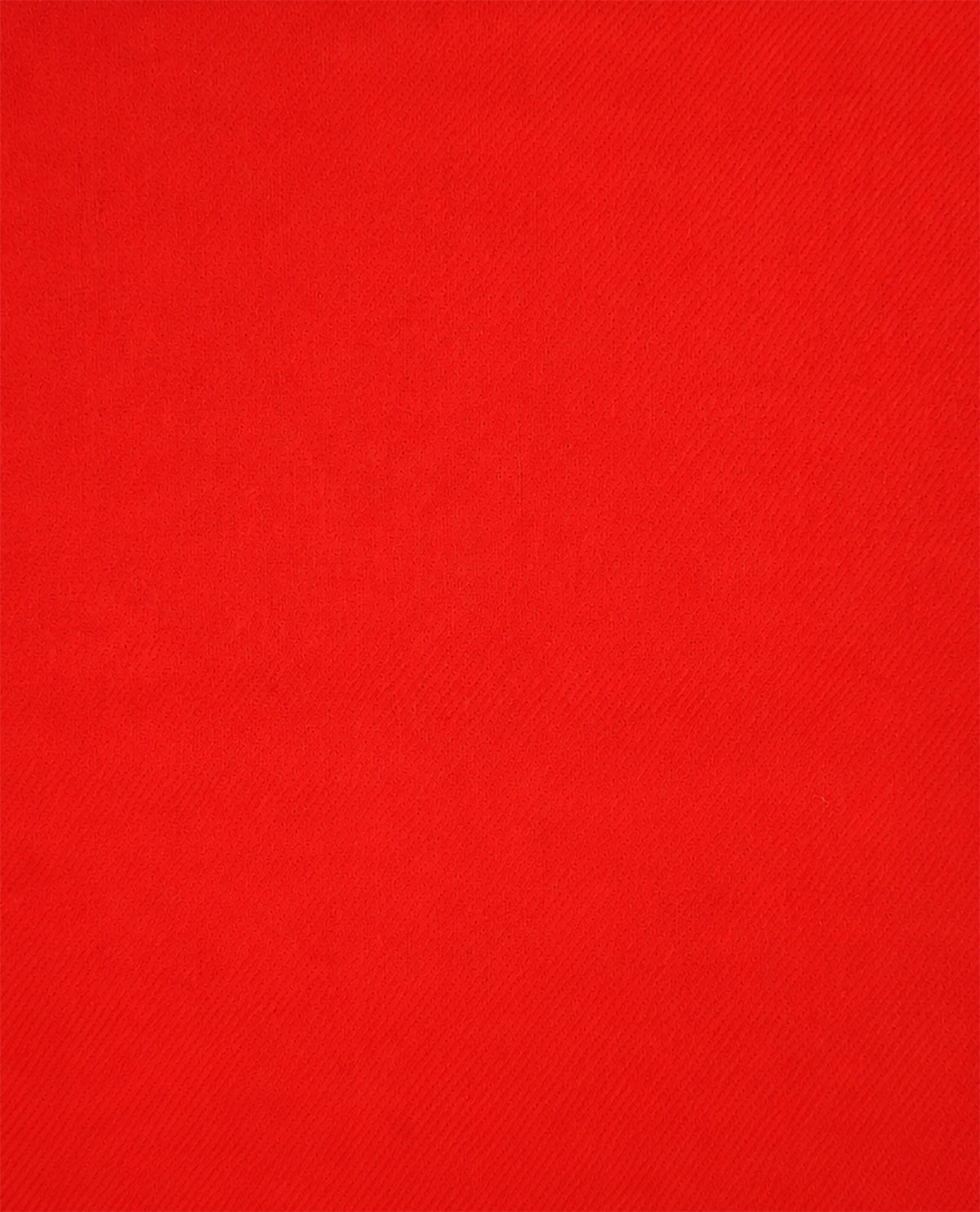 A close-up of a bright red textured fabric surface filling the frame.