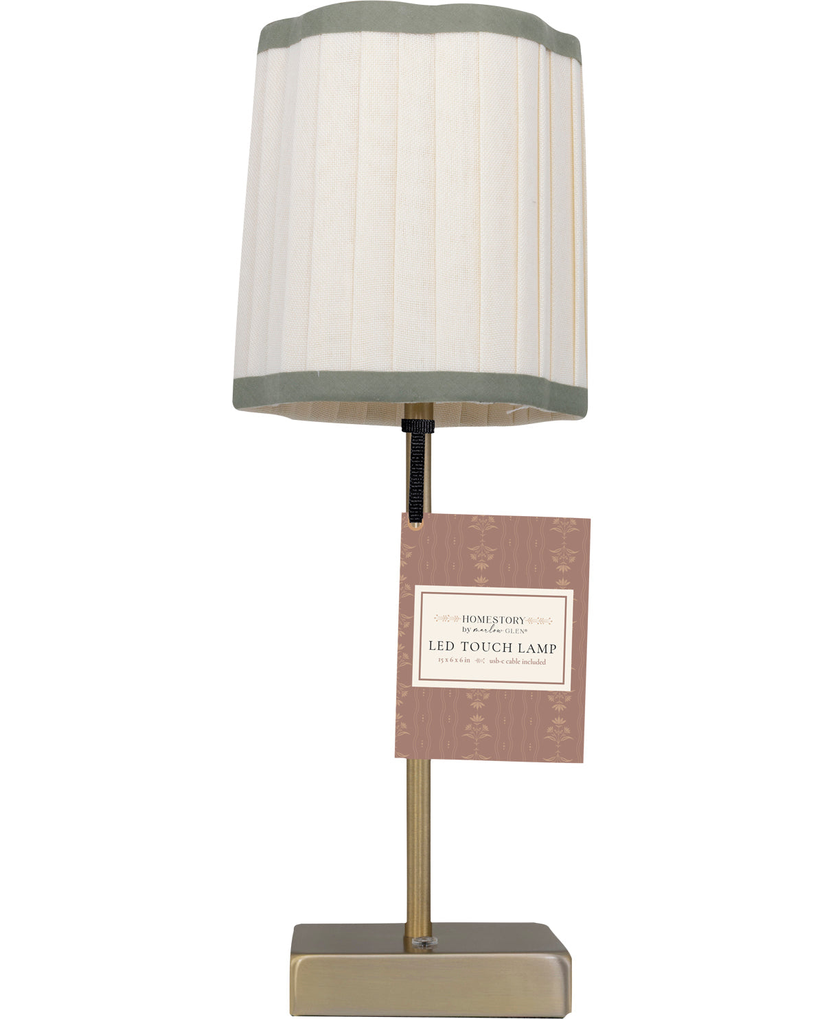 Table lamp with a white shade and gold base on a white background