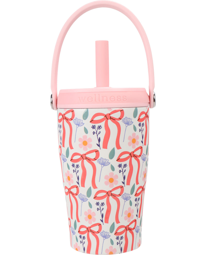 A pink Wellness insulated tumbler with a floral and ribbon pattern, featuring a pink handle and lid, set against a plain white background.