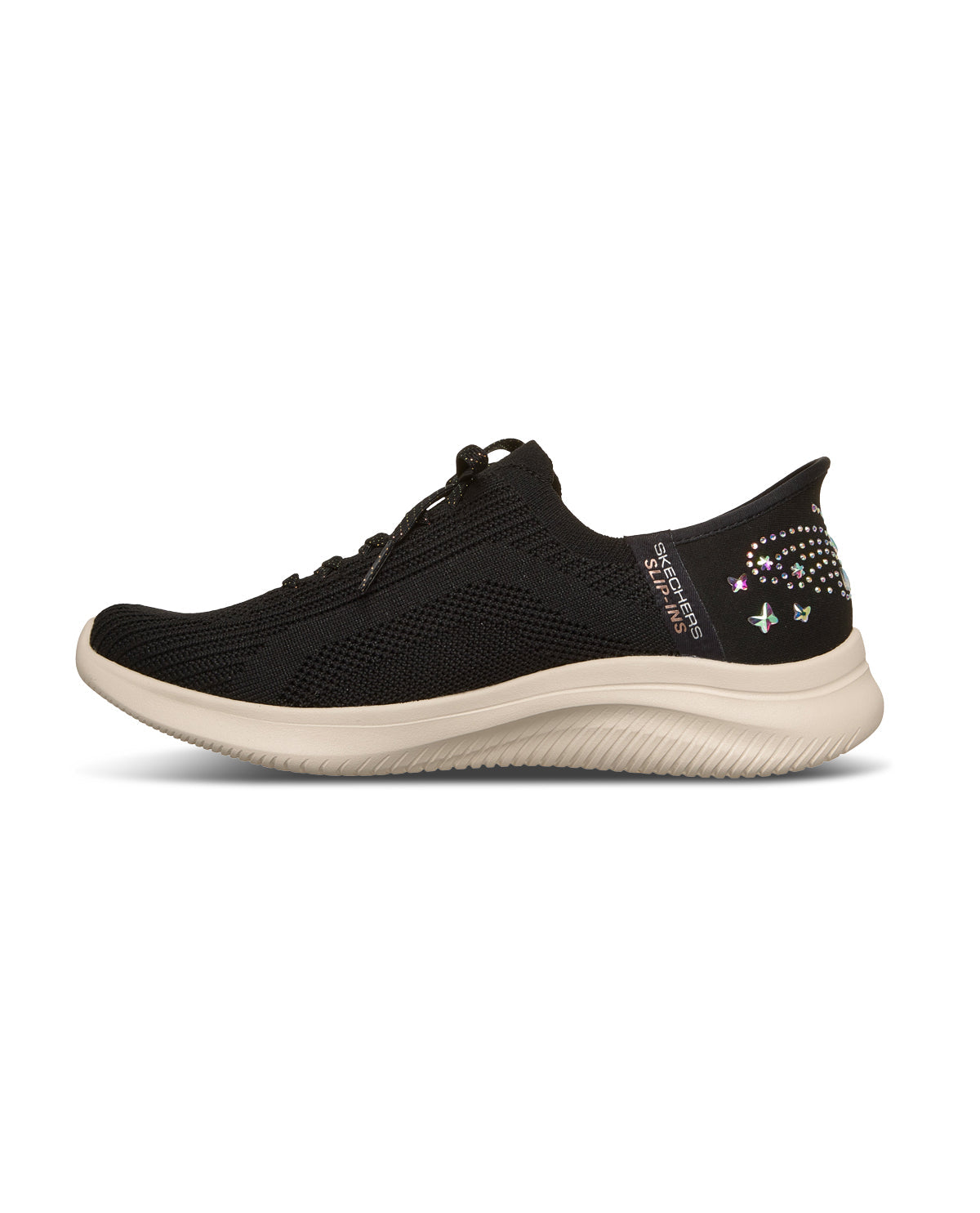 A black knit slip-on sneaker with a thick beige sole and decorative rhinestone embellishments on the heel, shown from a side profile on a white background.