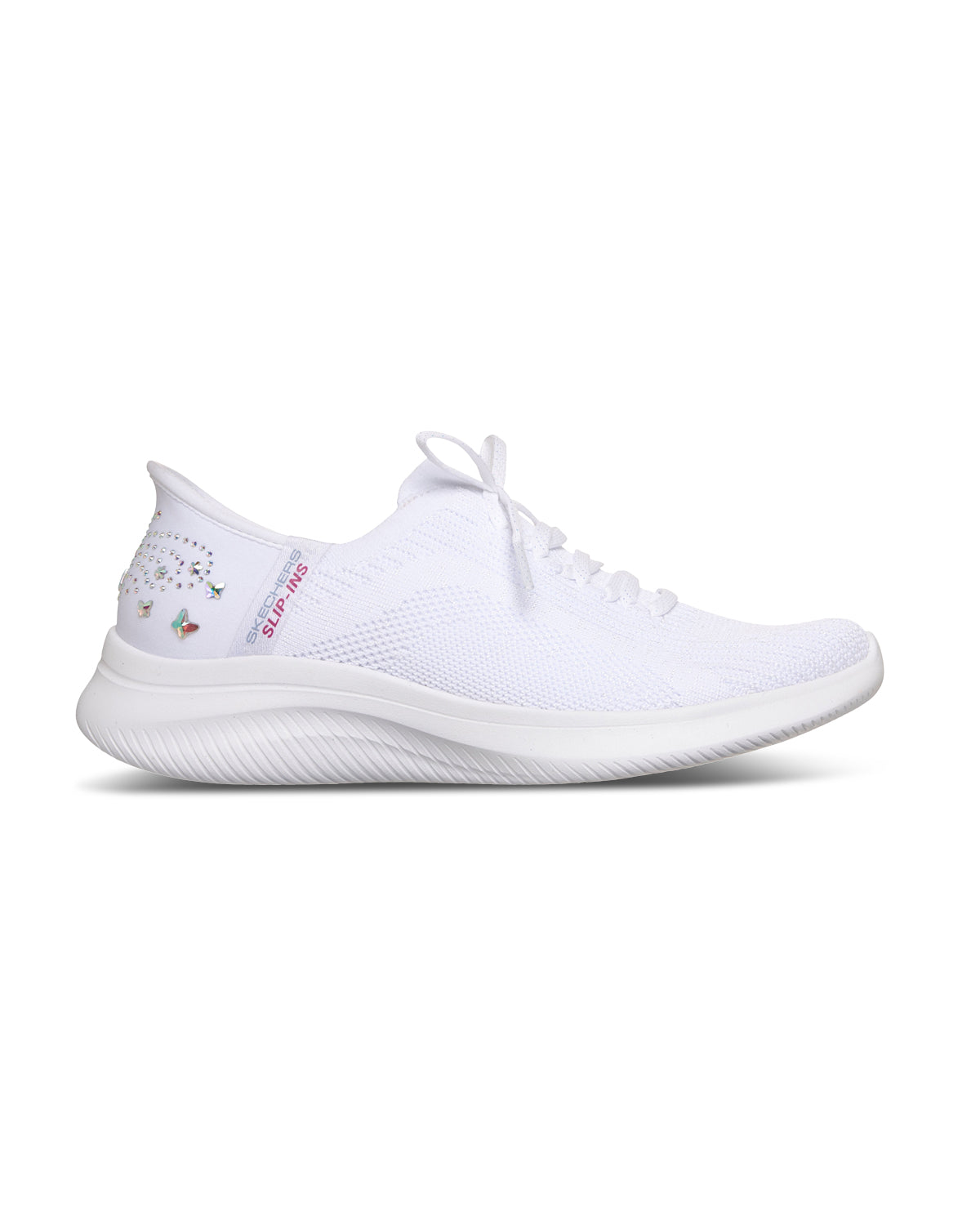 A white knit athletic sneaker with a thick white sole, shown in a side profile on a clean white background. The heel features small butterfly rhinestones and pink text that reads 'SLIP-INS'.