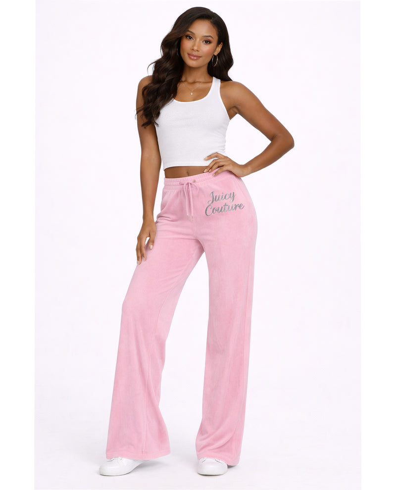 Woman wearing pink pants with 'Juicy Couture' branding on a white background