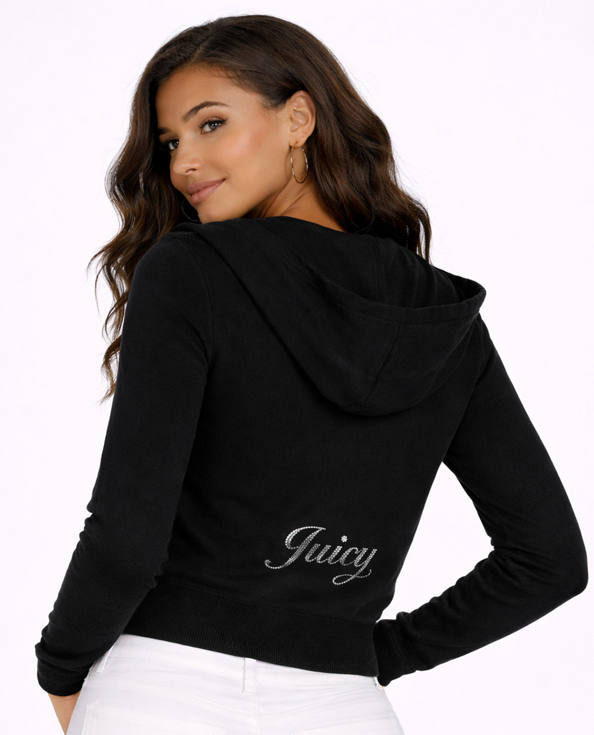 Woman wearing a black hoodie with 'Juicy' branding on a white background