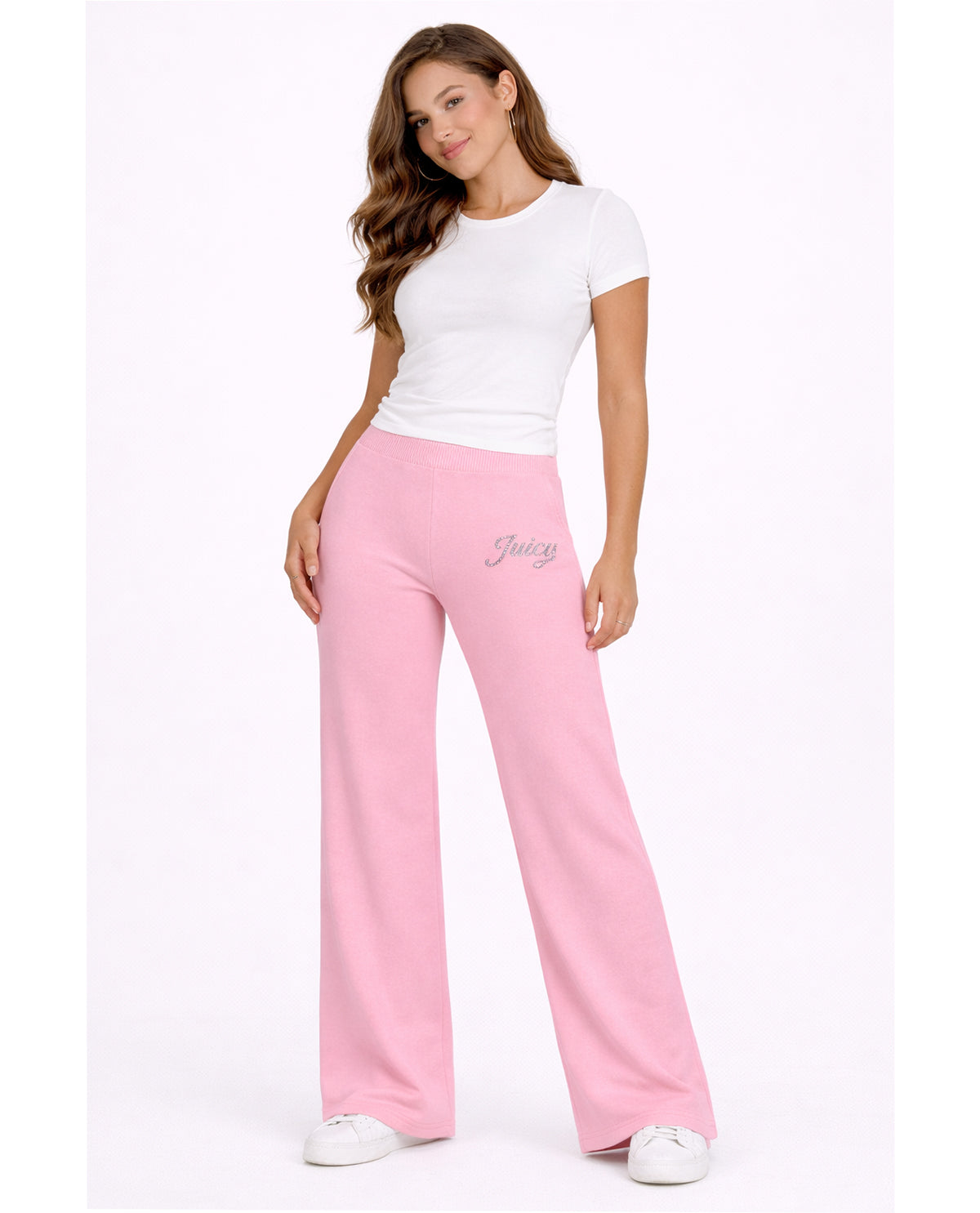 Woman wearing pink pants and a white top on a white background