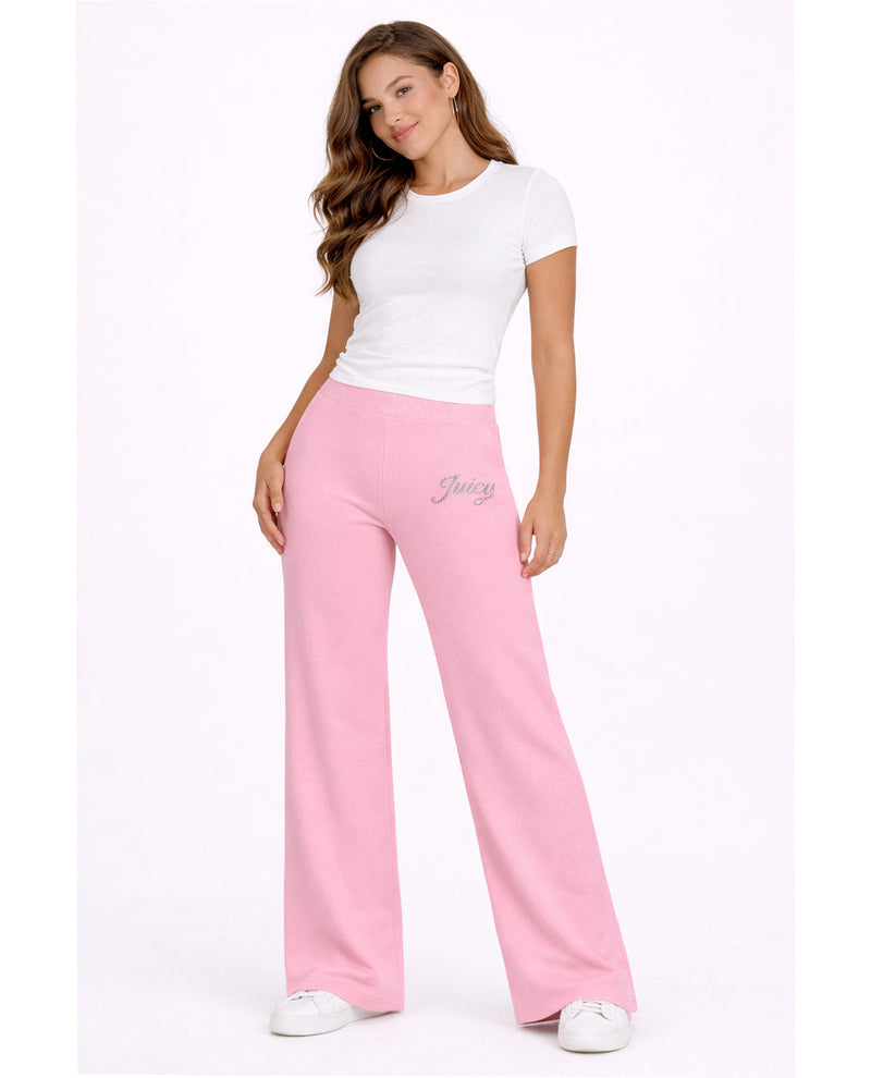 Woman wearing pink pants and a white top on a white background
