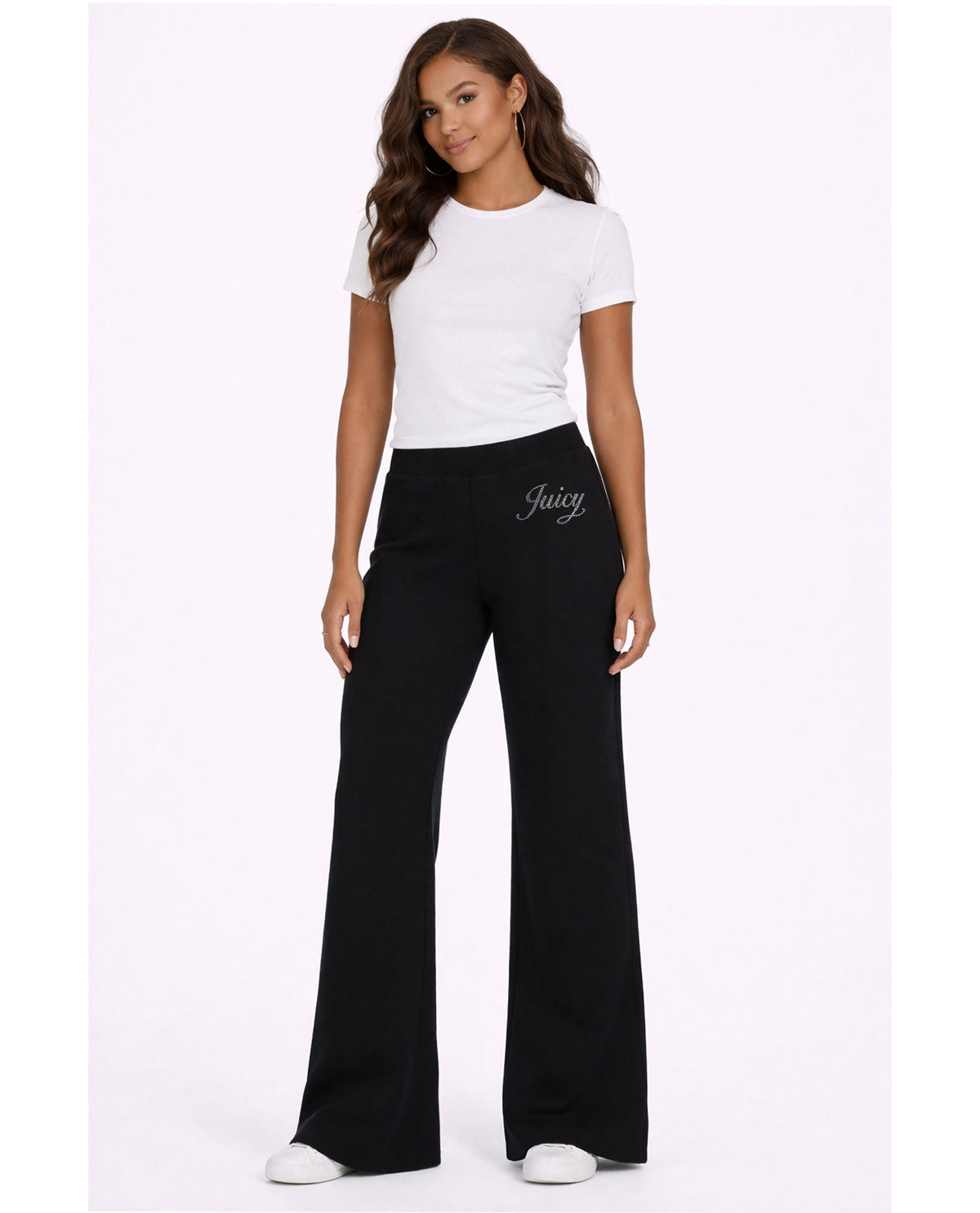 Woman wearing a white t-shirt and black pants with 'Juicy' branding on a white background