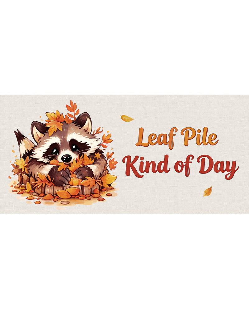 Cartoon raccoon surrounded by autumn leaves with text 'Leaf Pile Kind of Day' on a beige background