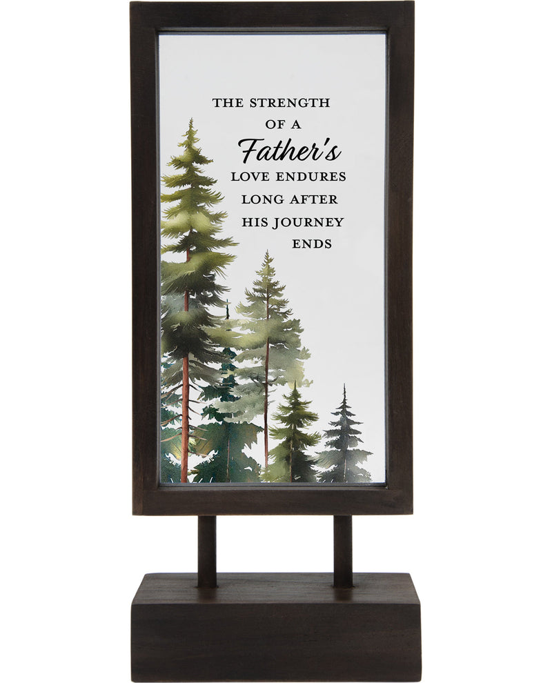 Decorative sign with trees and a quote on a stand against a white background