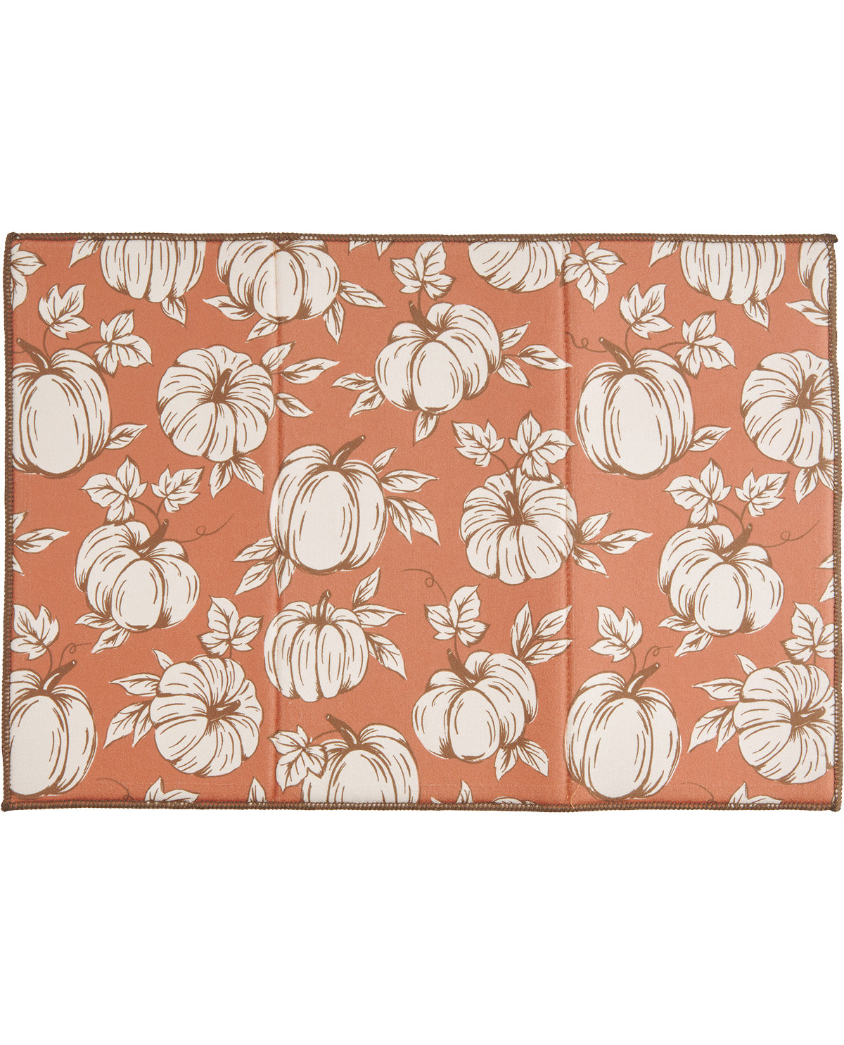 Folding table with white pumpkin pattern on a coral background