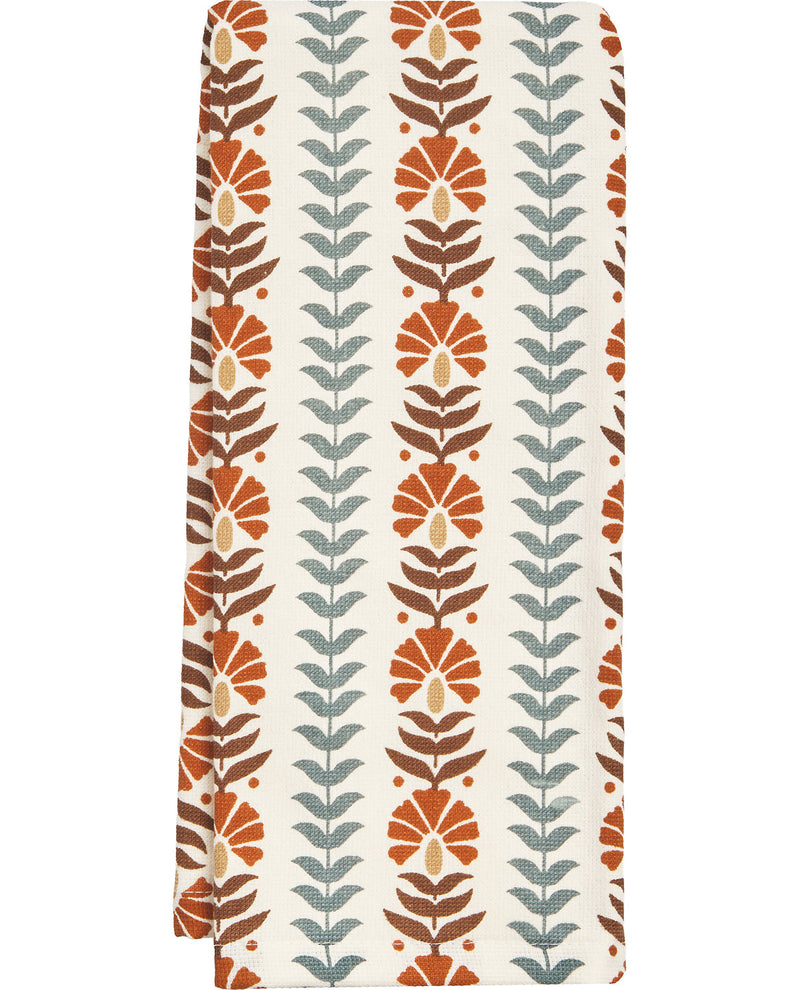 Patterned fabric with vertical leaf design on a white background