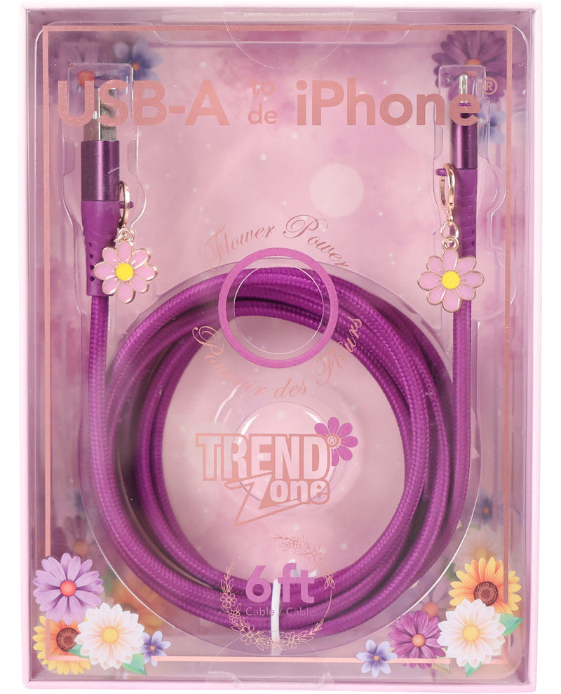 A purple braided USB-A to iPhone charging cable with flower-shaped connectors, packaged in a clear plastic box with pink floral graphics and the brand name Trend Zone.
