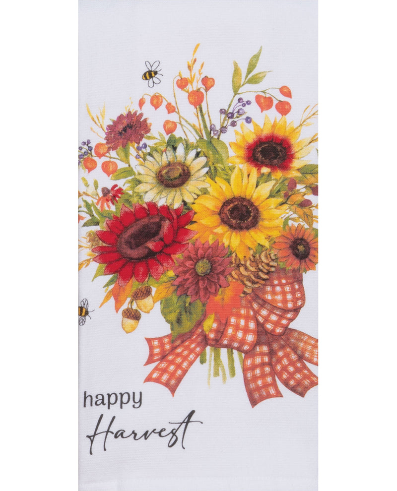 Decorative towel with autumn-themed floral design and 'happy harvest' text on a white background.