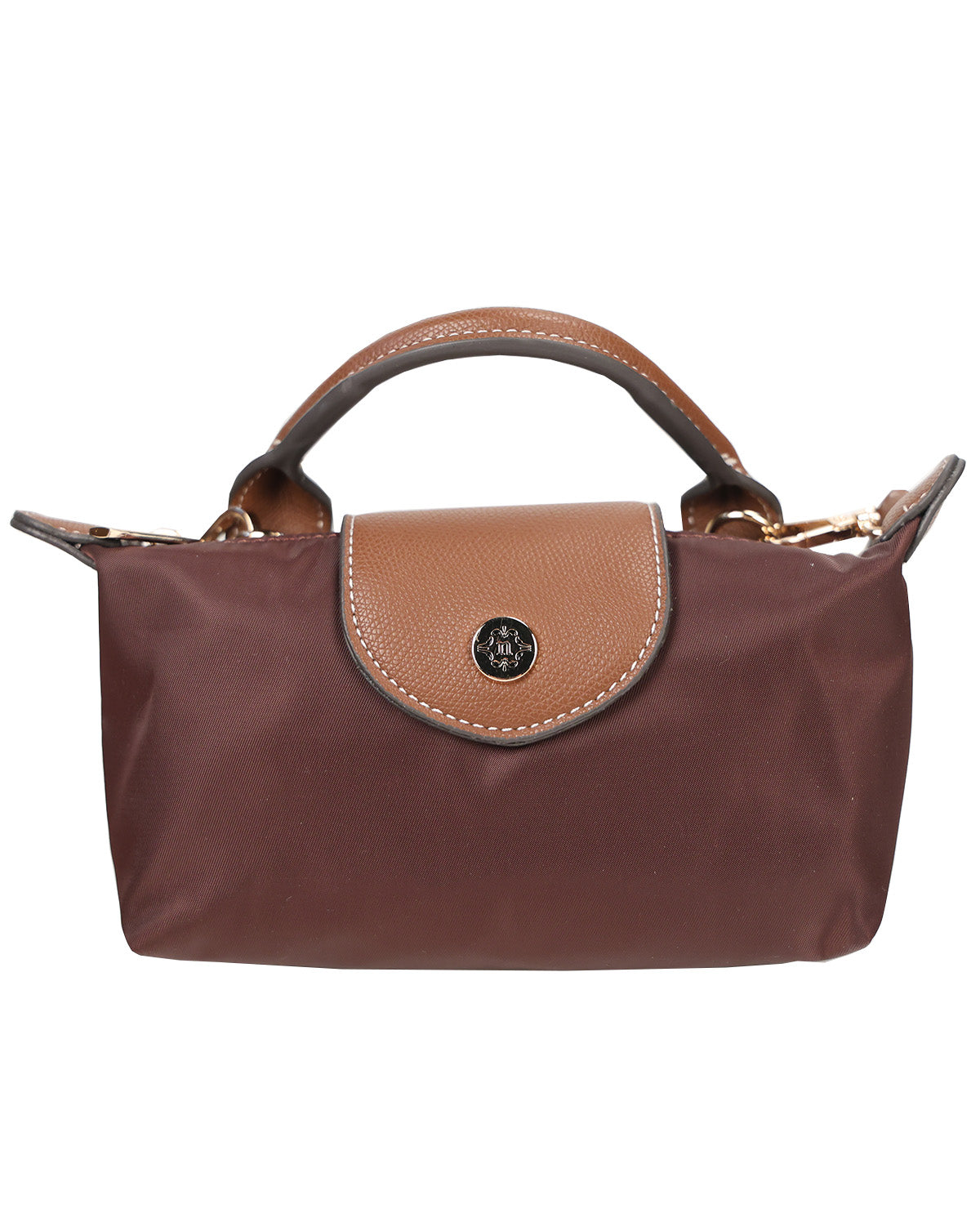 A brown nylon handbag with a tan leather top handle and front flap, featuring a circular black metal logo emblem in the center.