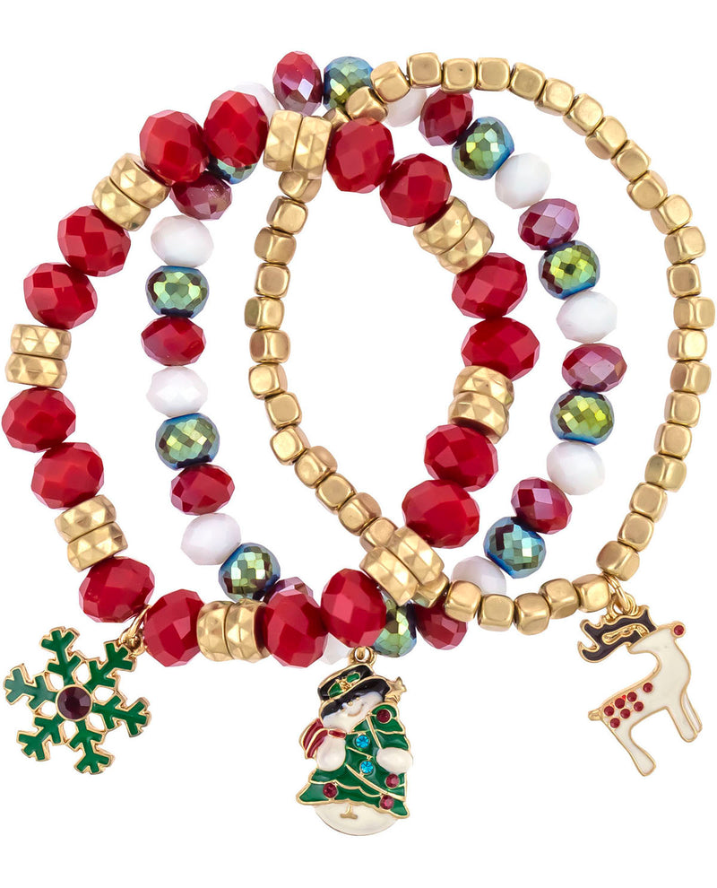 Three beaded stretch bracelets with red, gold, white, and green faceted beads, featuring holiday-themed charms including a snowflake, a Christmas tree with a snowman, and a reindeer, on a white background.