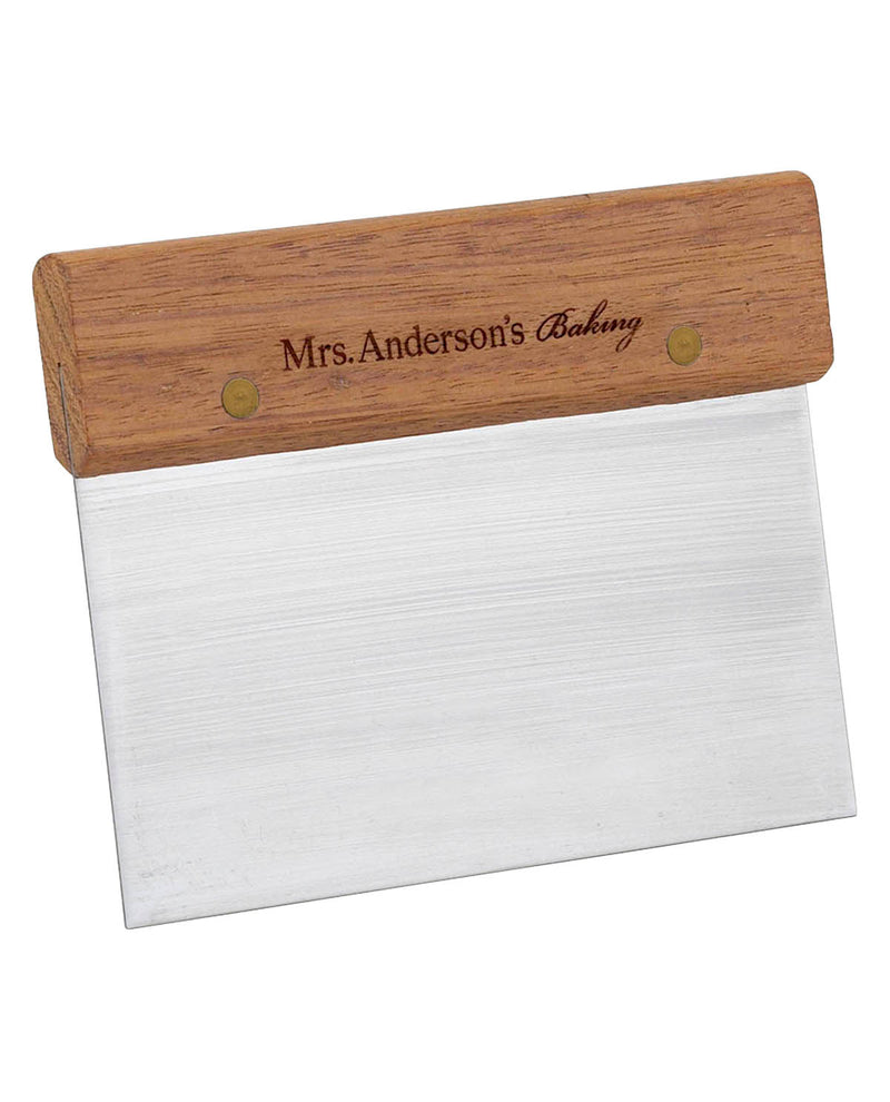 Baking spatula with wooden handle and engraved text on a white background