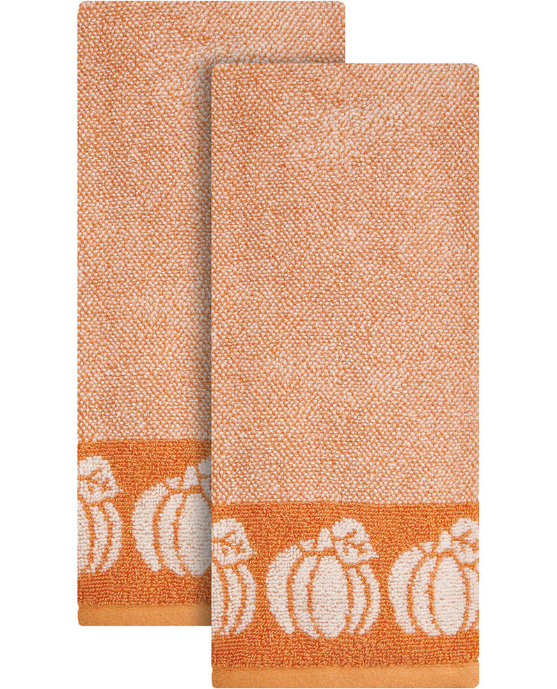 Two orange towels with white pumpkin designs on a white background