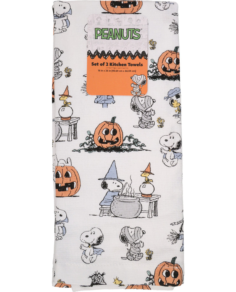 A set of three Peanuts-themed kitchen towels featuring Snoopy and Woodstock in Halloween costumes on an off-white background, with a cardboard header card.
