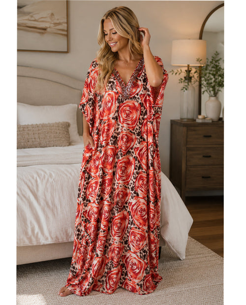 Woman wearing a red floral dress in a bedroom setting