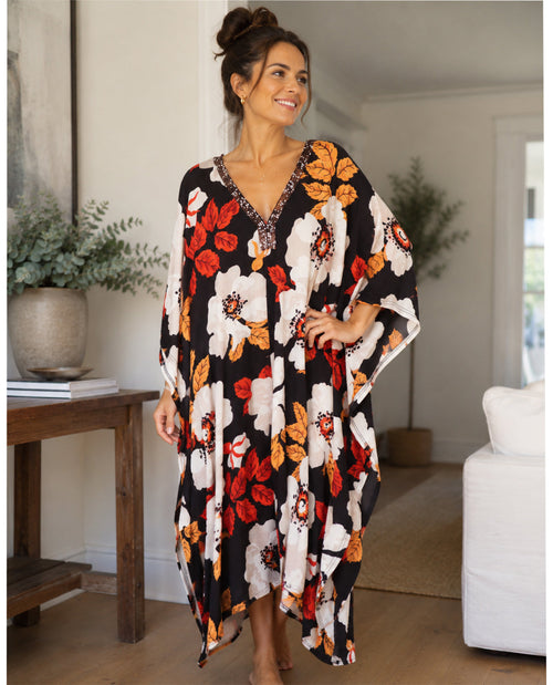 Woman wearing a floral dress in a home setting