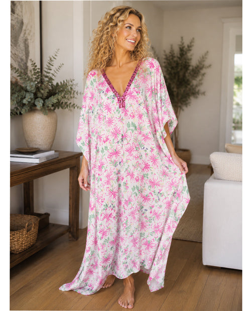 Woman wearing a floral caftan in a home setting