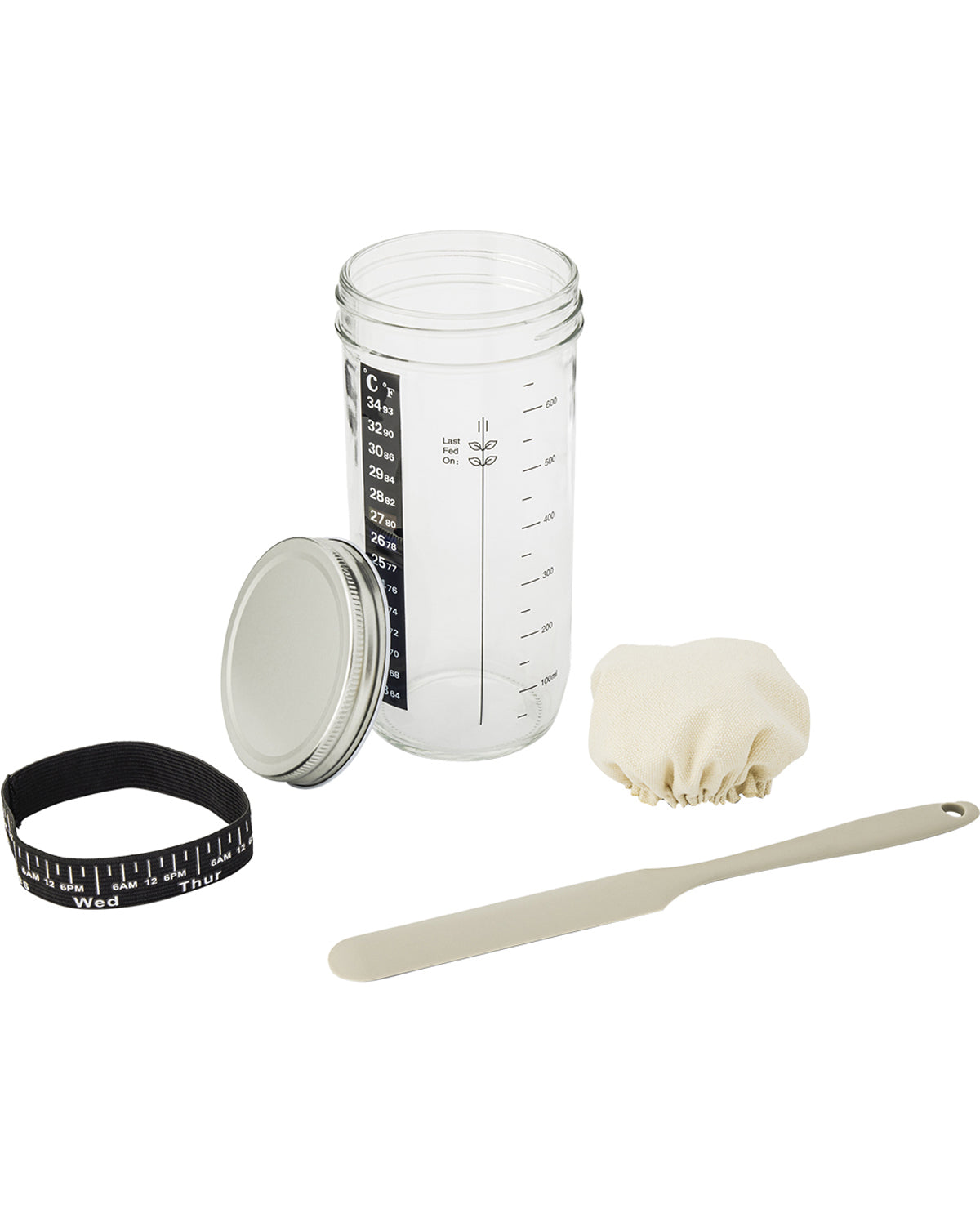 Baking set with a measuring jar, spatula, and other tools on a white background