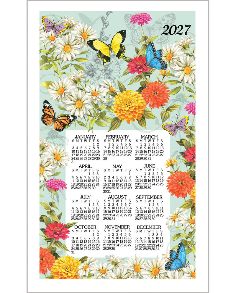 A 2027 wall calendar featuring a colorful floral and butterfly illustration on a pale blue background, with the months displayed in a grid near the bottom.