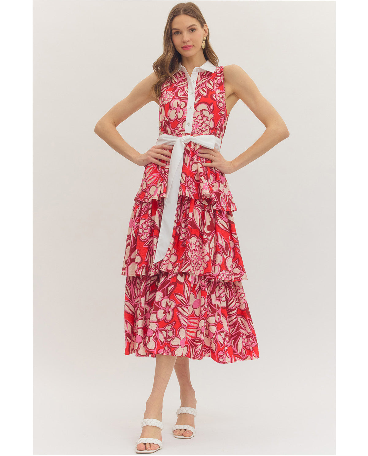 Woman wearing a red floral dress on a white background