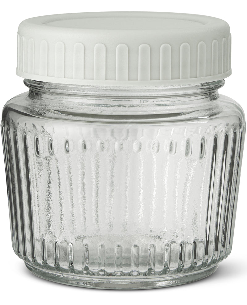 Clear glass jar with a white lid on a white background