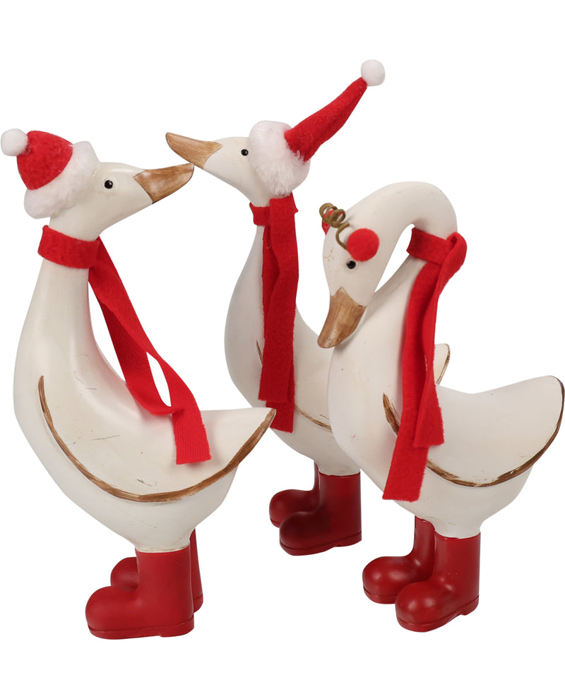 Three white decorative swans wearing red Santa hats, red felt scarves, and red boots, arranged together on a plain white background.