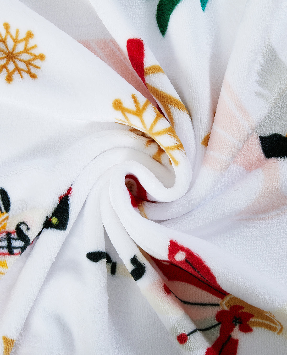 A close-up of a white plush fabric with a colorful holiday print, including red and gold snowflakes, green leaves, and black accents, arranged in a spiral drape.