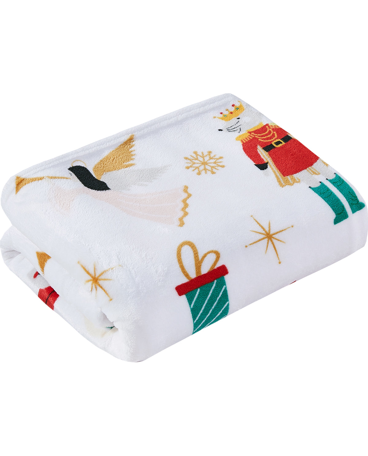 A folded white plush blanket featuring a festive Christmas print with a nutcracker, angel, snowflakes, and gift boxes in red, green, and gold.