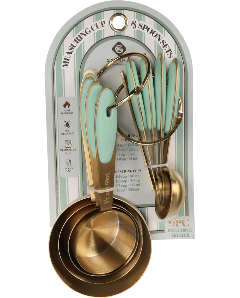 An 8-piece measuring cup and spoon set in a hanging retail package. The set includes matte gold-toned metal measuring cups and spoons with mint green handles, alongside matching utensils.