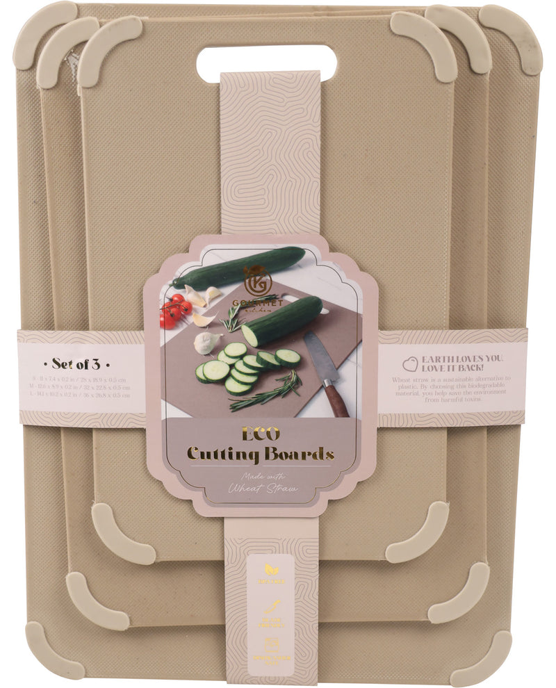 A set of three beige plastic cutting boards stacked together, each with a handle cutout and protective corner guards. A central paper label reads 'LCU Cutting Boards' and shows vegetables and a knife.