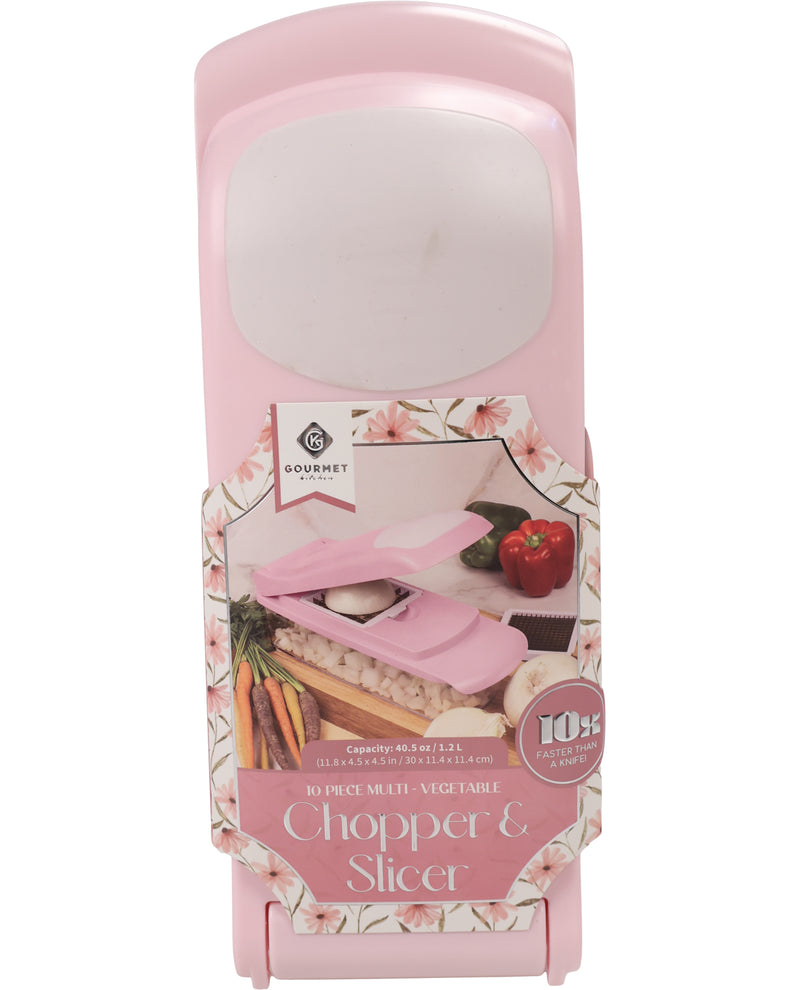 A pink countertop chopper and slicer shown in its retail packaging against a white background. The packaging features a floral border and an illustration of the pink device slicing vegetables.